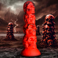 Creature Cocks Doom silicone dildo: a red, stackable skull-shaped design set against a dark, stormy mountain backdrop.