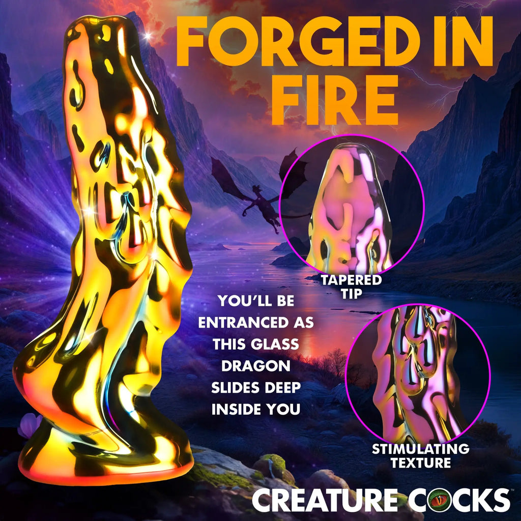 Creature Cocks Dragon Glass dildo in a reflective, iridescent gold finish with a textured surface against a fantasy backdrop.