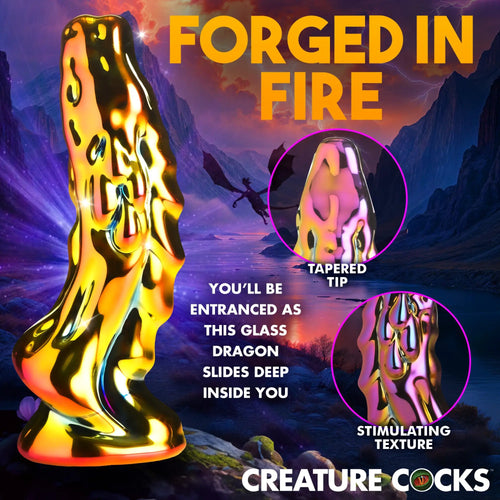 Creature Cocks Dragon Glass dildo in a reflective, iridescent gold finish with a textured surface against a fantasy backdrop.