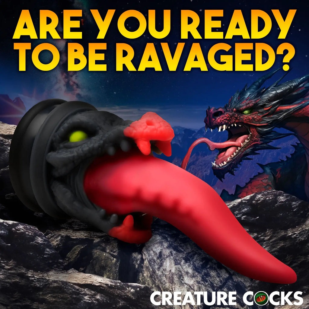 Creature Cocks Dragon Roar dildo: black textured head with red details and a long red tongue on a rocky landscape.