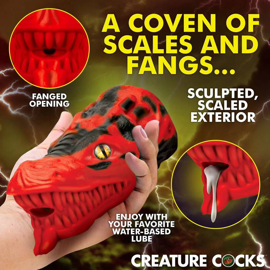 Creature Cocks Dragon Tamer red and black silicone stroker with a textured dragon scale exterior and a fanged opening.