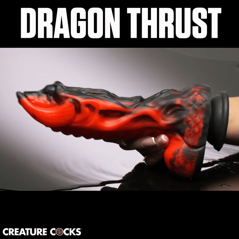 Creature Cocks Dragon Thrust dildo in a black and red marbled silicone dragon-inspired design held in a hand.