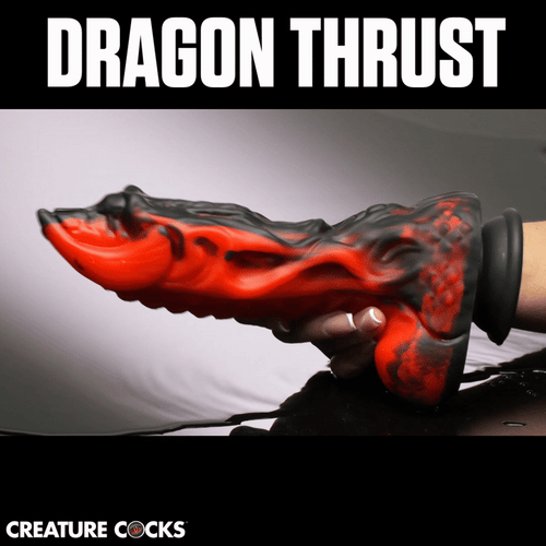 Creature Cocks Dragon Thrust dildo in a black and red marbled silicone dragon-inspired design held in a hand.