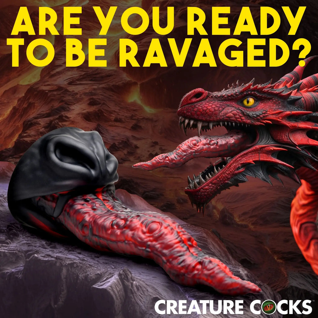 Creature Cocks Dragon Tongue silicone dildo in black and red, shown next to a dragon in a volcanic landscape.