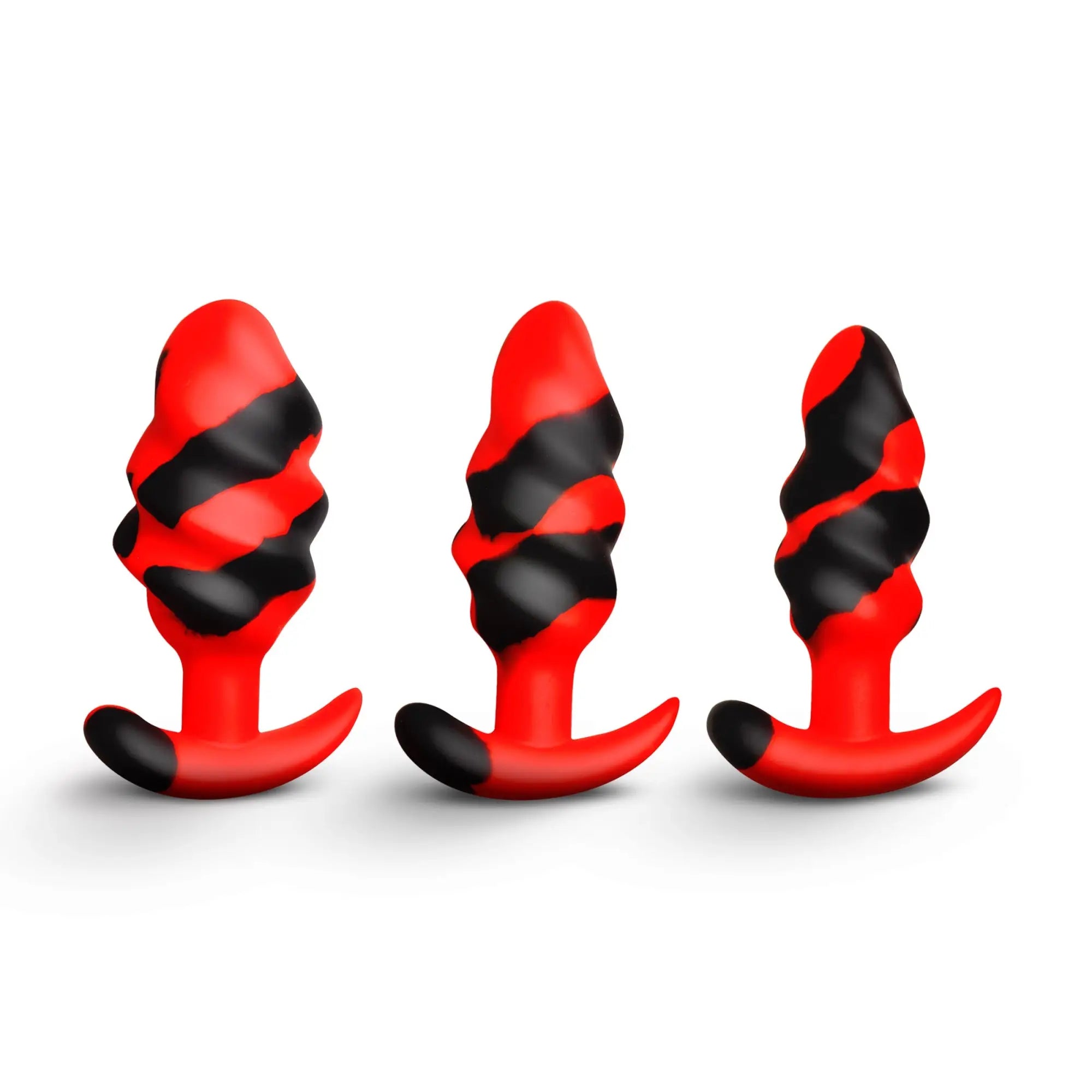 Creature Cocks Dragon Trainer silicone plug set in varying sizes, featuring a red and black swirled, ribbed design.