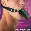 Creature Cocks Dragon's Lick: a green-and-black textured vibrating oral enhancer on a black leather head harness.