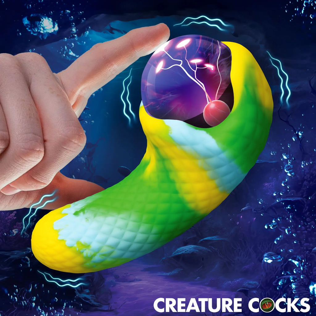 Creature Cocks Electric Eye vibrator: A green and yellow textured, curved device with a glowing purple plasma orb top.