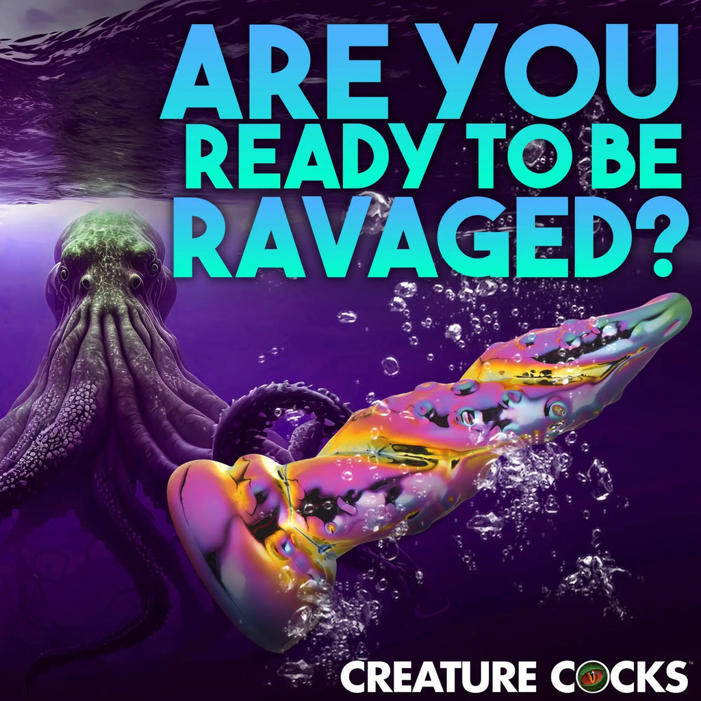 Creature Cocks Enchantress rainbow glass dildo with a textured, spiral design submerged near an octopus.