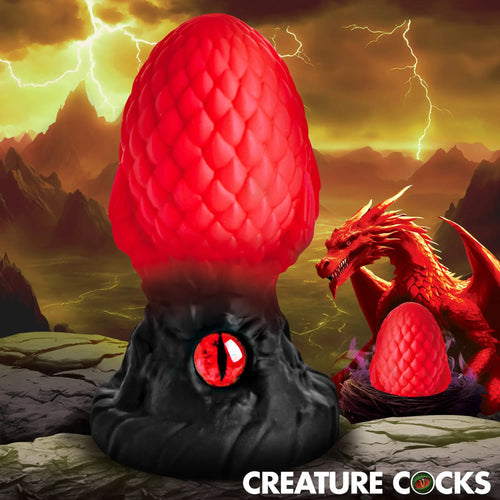 Creature Cocks Eye of the Dragon silicone butt plug with a red scale-textured head, black base, and dragon eye accent.