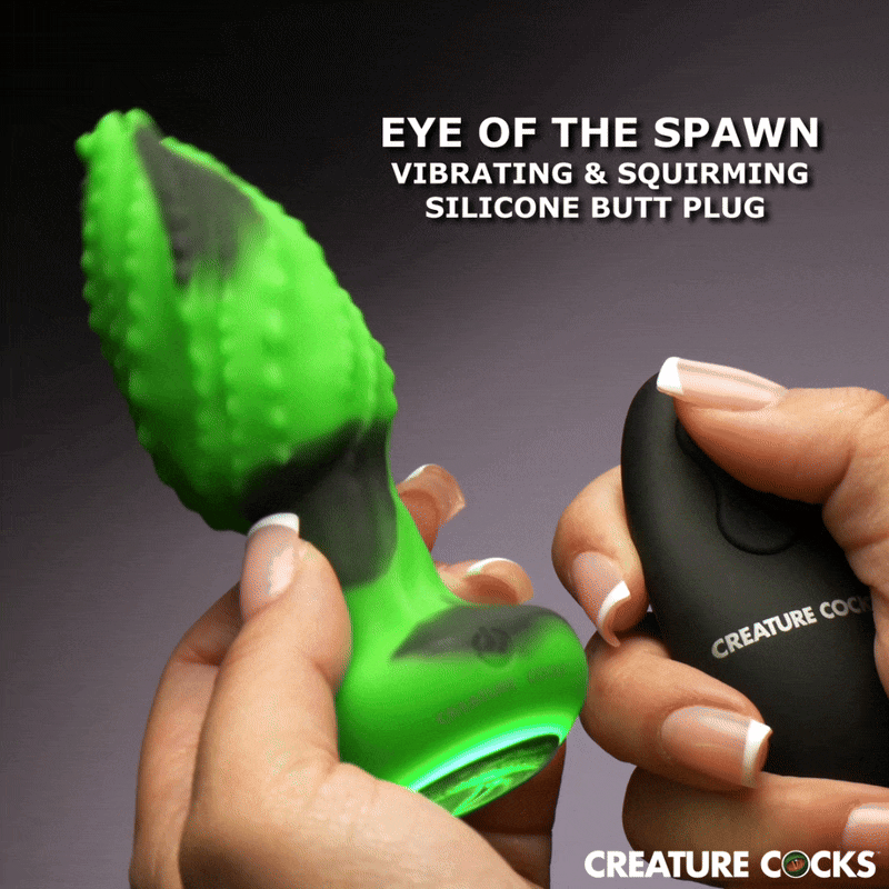 A neon green, textured Creature Cocks Eye of the Spawn vibrating silicone butt plug being held next to a black remote.