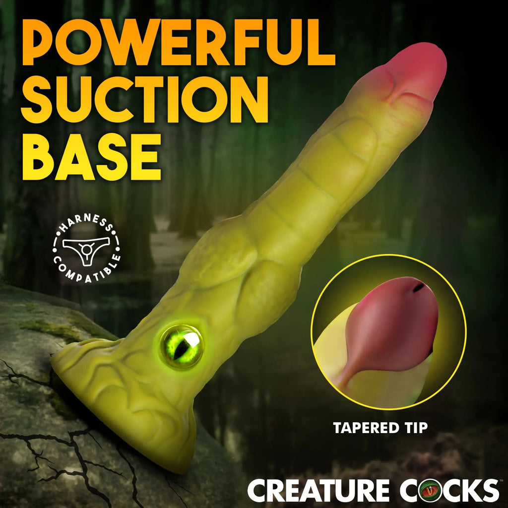 Creature Cocks Eyegor dildo: yellow-green monster-themed silicone toy with a central eye, suction base, and tapered tip.