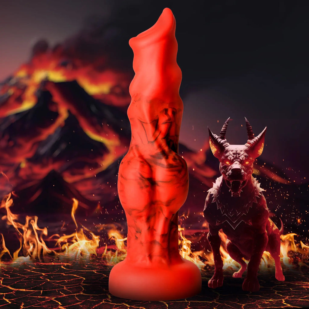 Creature Cocks Fire Hound silicone dildo: a red and black textured fantasy toy next to a hellhound in a volcano scene.
