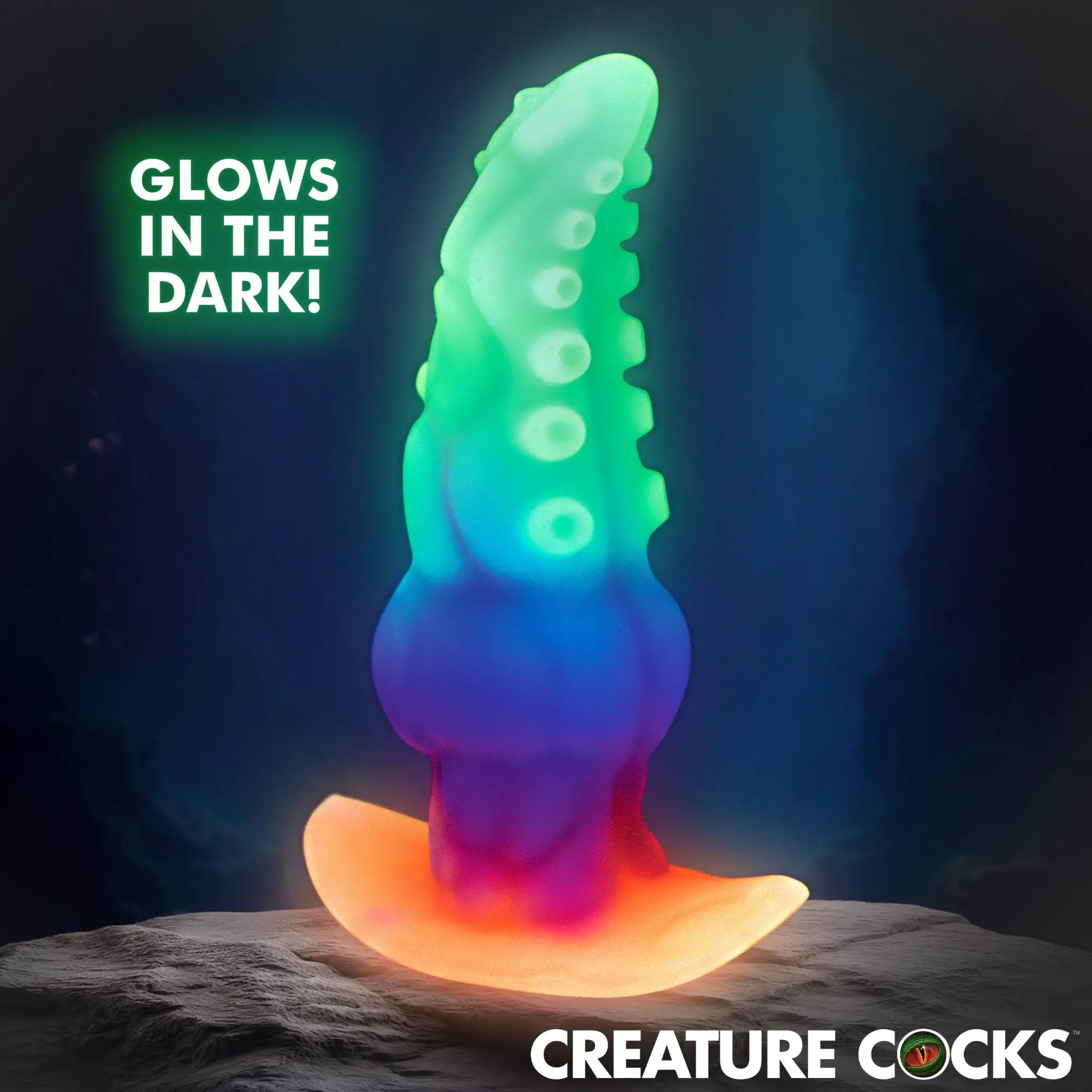 Creature Cocks Glowtopus: A multi-colored, glow-in-the-dark silicone tentacle-style anal plug standing on a rock base.