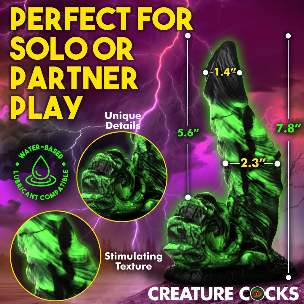 Creature Cocks Glowzilla dildo: a textured, glow-in-the-dark green silicone toy with dimensions on a stormy background.