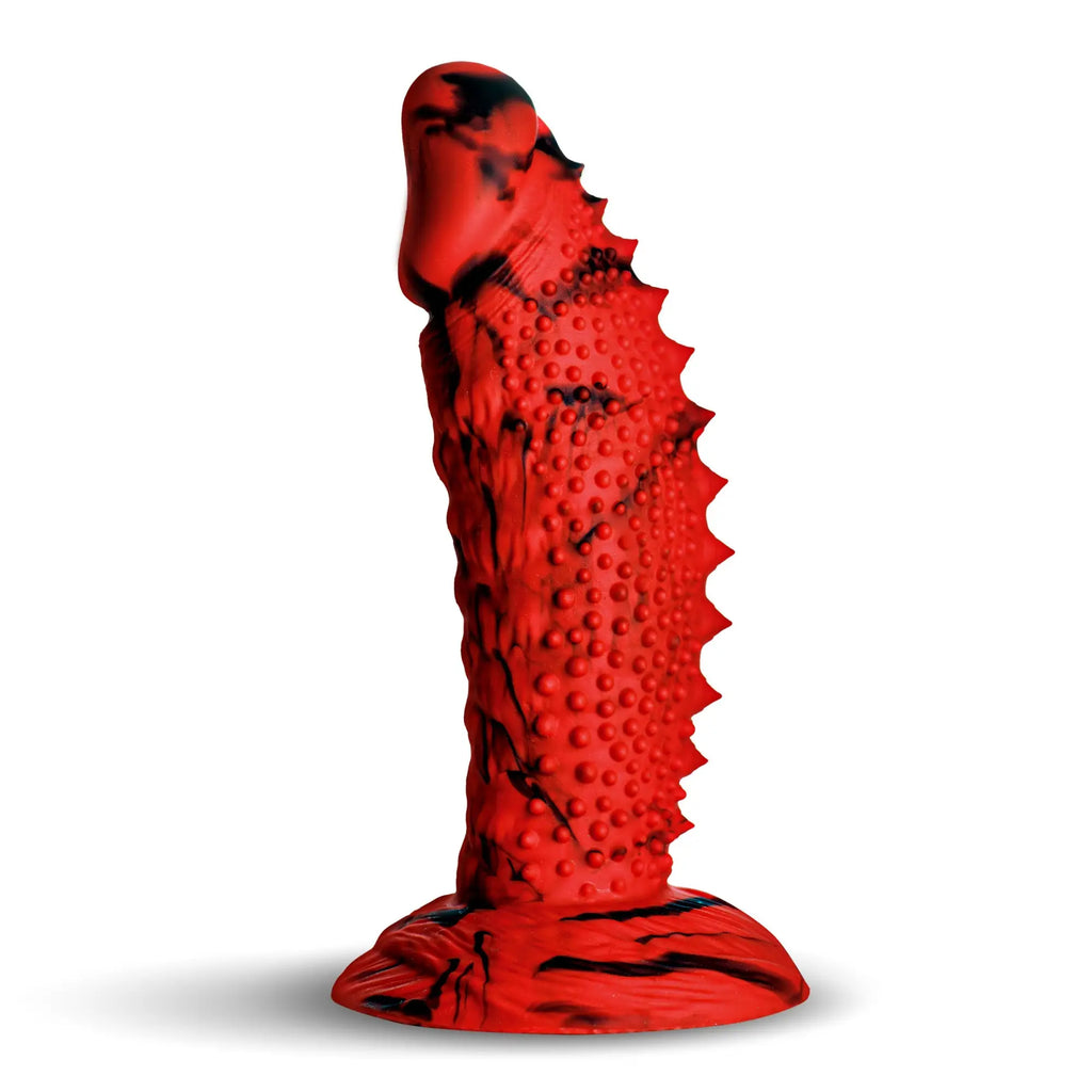 Creature Cocks Gojira silicone dildo in red with black marbling, featuring a spiked spine and textured shaft.