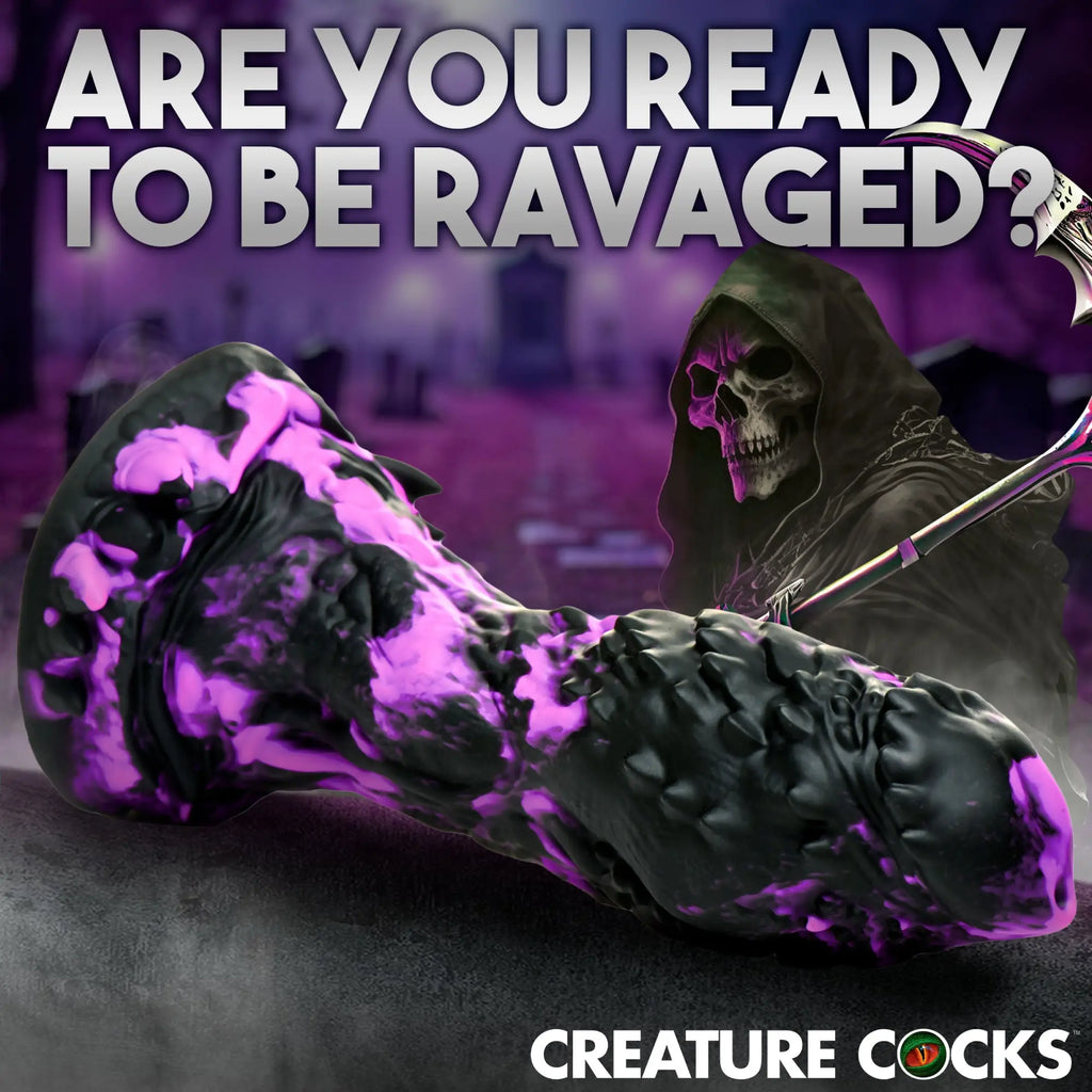 Creature Cocks Grim silicone dildo: a textured black and purple fantasy-style toy with a grim reaper graveyard background.