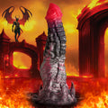 Creature Cocks Hades silicone dildo: a red and black textured, fantastical phallic toy against a fiery hellscape backdrop.