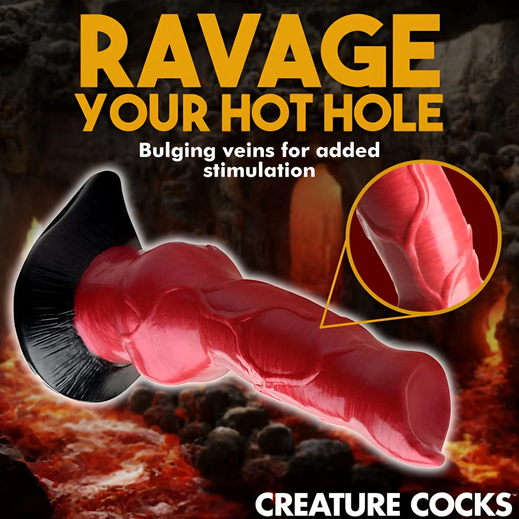 Creature Cocks Hell-Hound dildo: a red, veined silicone canine-style toy with a black base against a volcanic background.