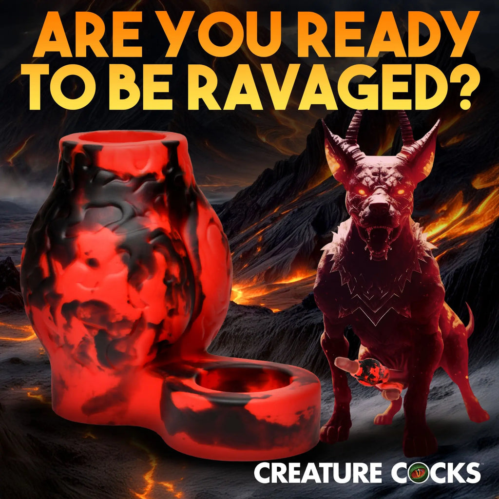 Creature Cocks Hell Hound girth enhancer in red and black marbled silicone with a ball strap against a lava background.