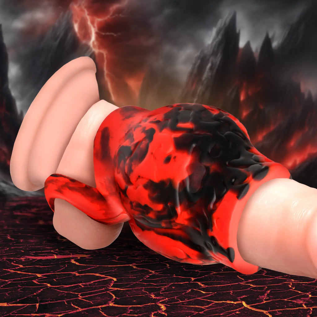 Creature Cocks Hell Hound silicone girth enhancer with a black and red marbled design and integrated ball strap.