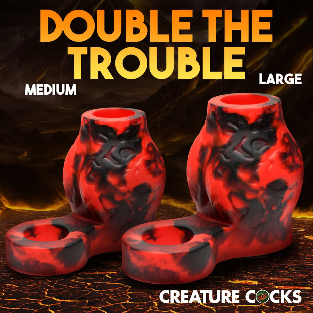 Creature Cocks Hell Hound silicone girth enhancers in red and black marbled lava print, featuring a built-in ball strap.