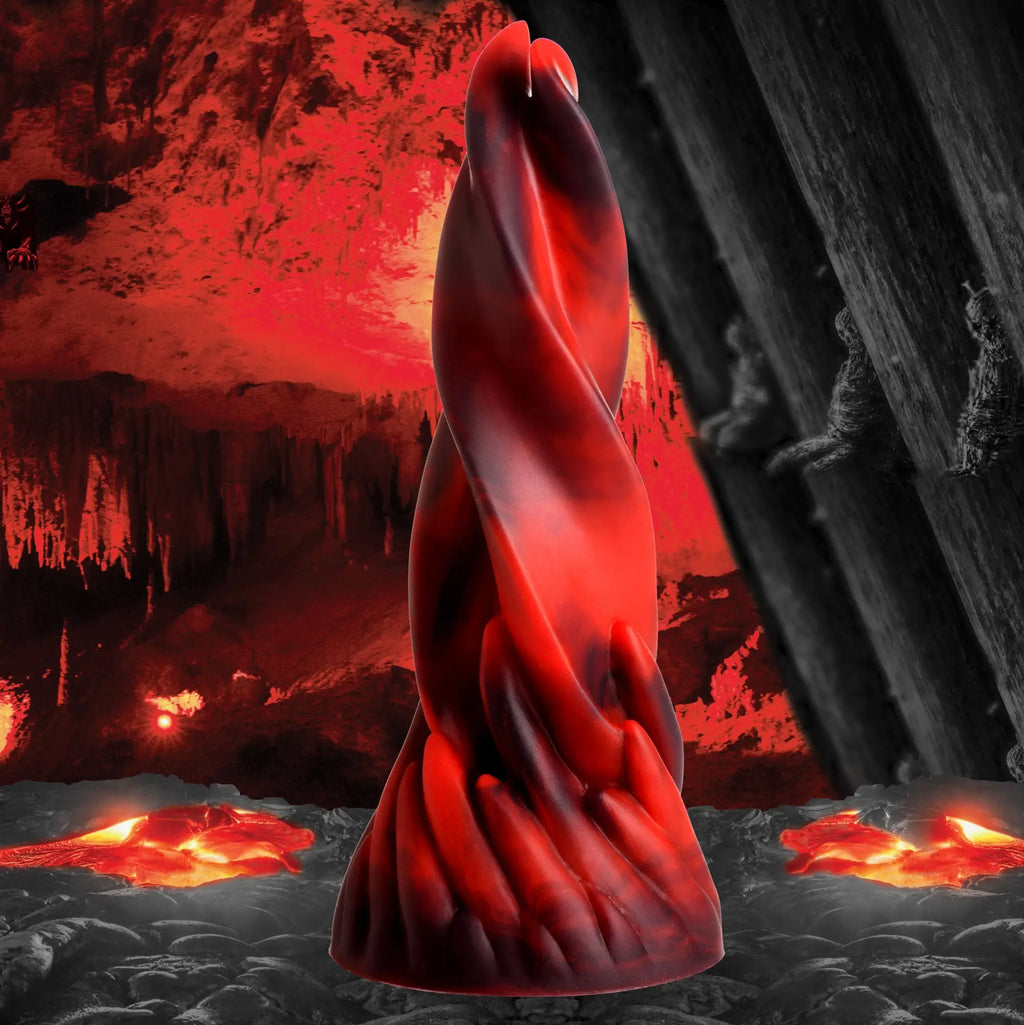 Creature Cocks Hell Kiss Twisted Tongues silicone dildo in marbled red and black, set against a volcanic landscape.