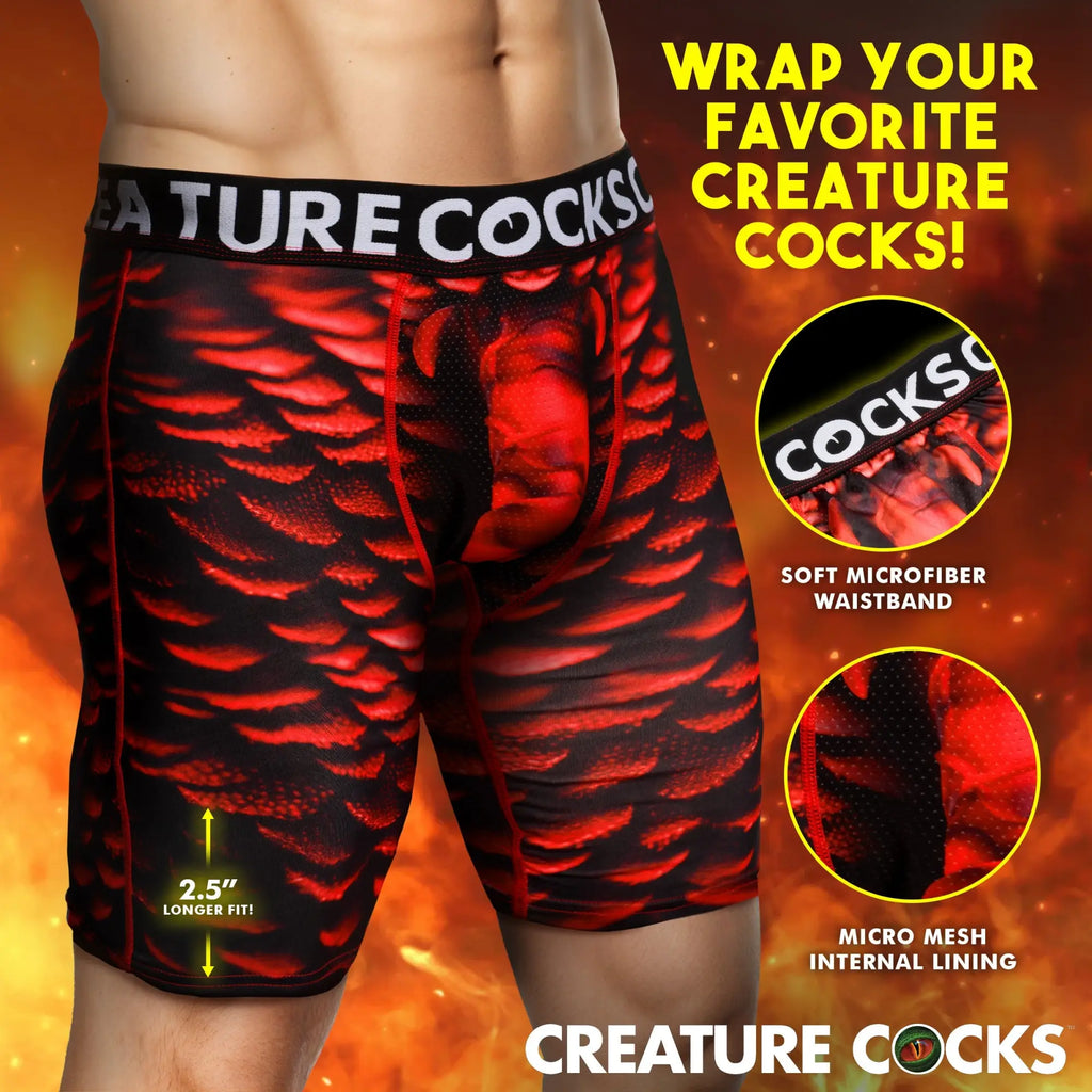 Creature Cocks Horny Devil boxer shorts in red and black scale print with a branded waistband on a male model.