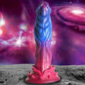 Creature Cocks Intruder silicone dildo in blue and magenta with alien, textured detailing against a space background.