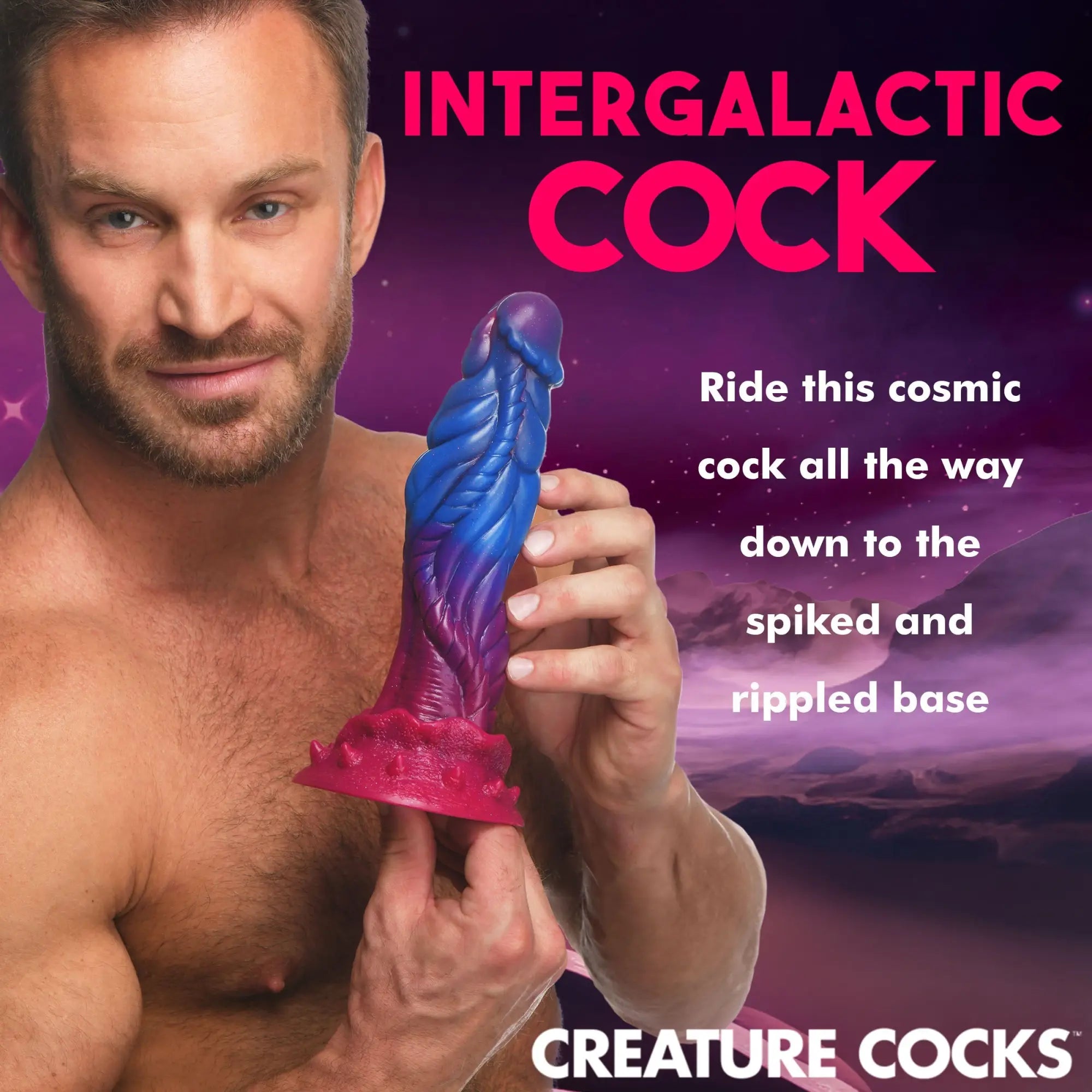 A man holds a blue and purple textured Creature Cocks Intruder alien dildo with a wide, spiked pink base.