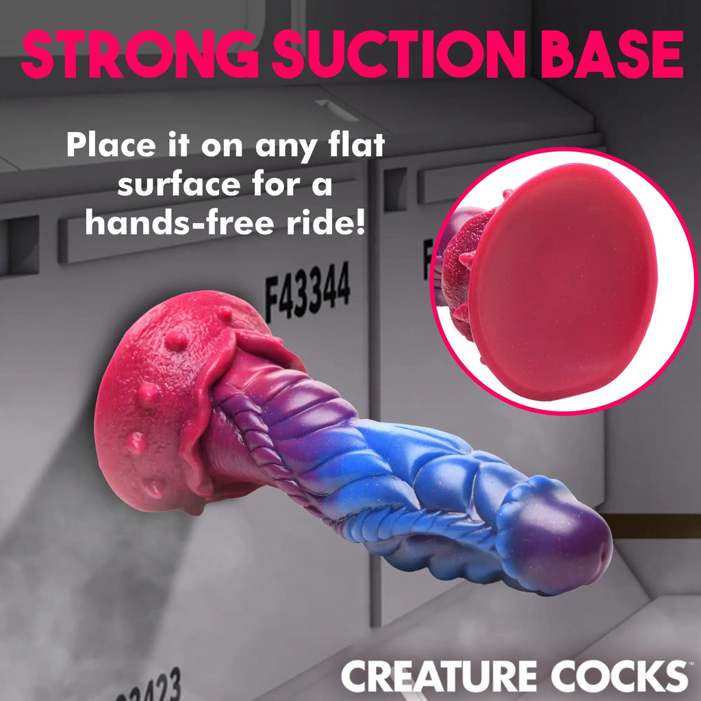 Creature Cocks Intruder silicone dildo in pink-to-blue gradient, featuring alien textures and a strong suction base.