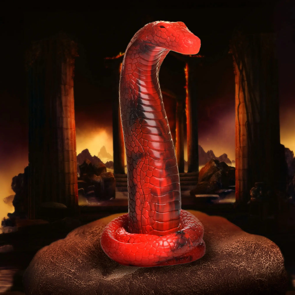 Creature Cocks King Cobra silicone dildo in bright red with black marbling, coiled base, and textured scale details.