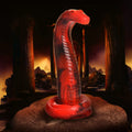 Creature Cocks King Cobra silicone dildo in bright red with black marbling, coiled base, and textured scale details.