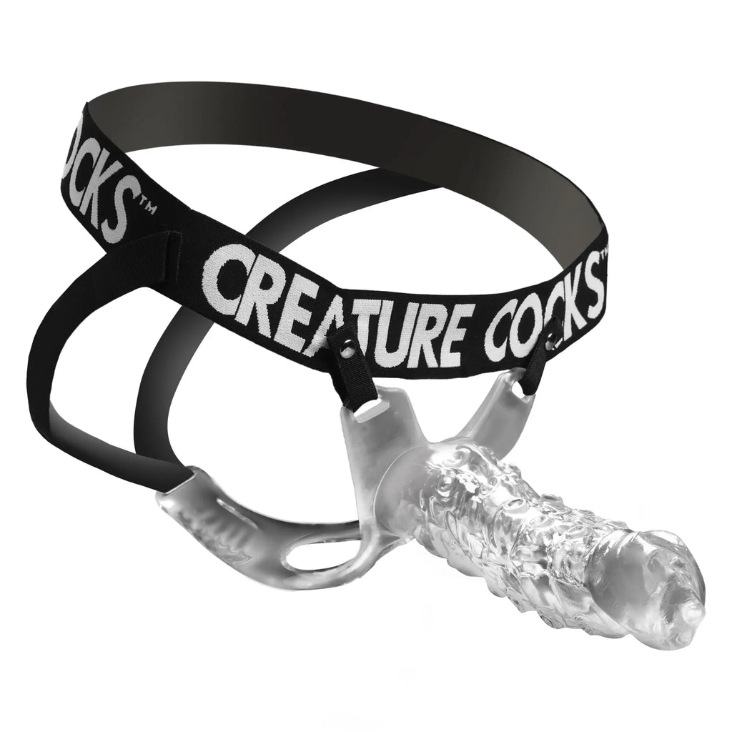 Creature Cocks King Kraken clear textured hollow strap-on with black branded elastic harness on a white background.