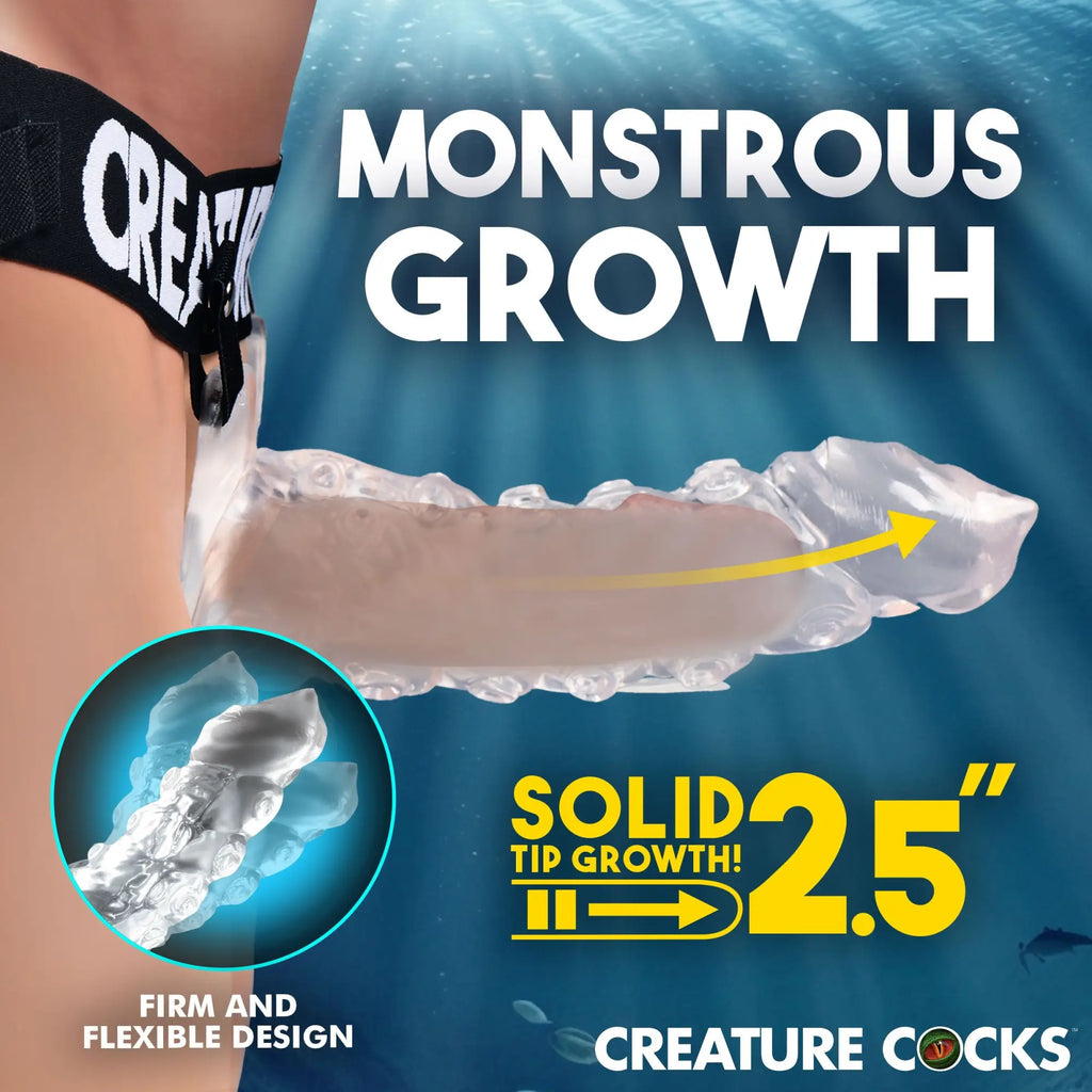 Creature Cocks King Kraken clear hollow strap-on dildo with black harness on an underwater-themed background.