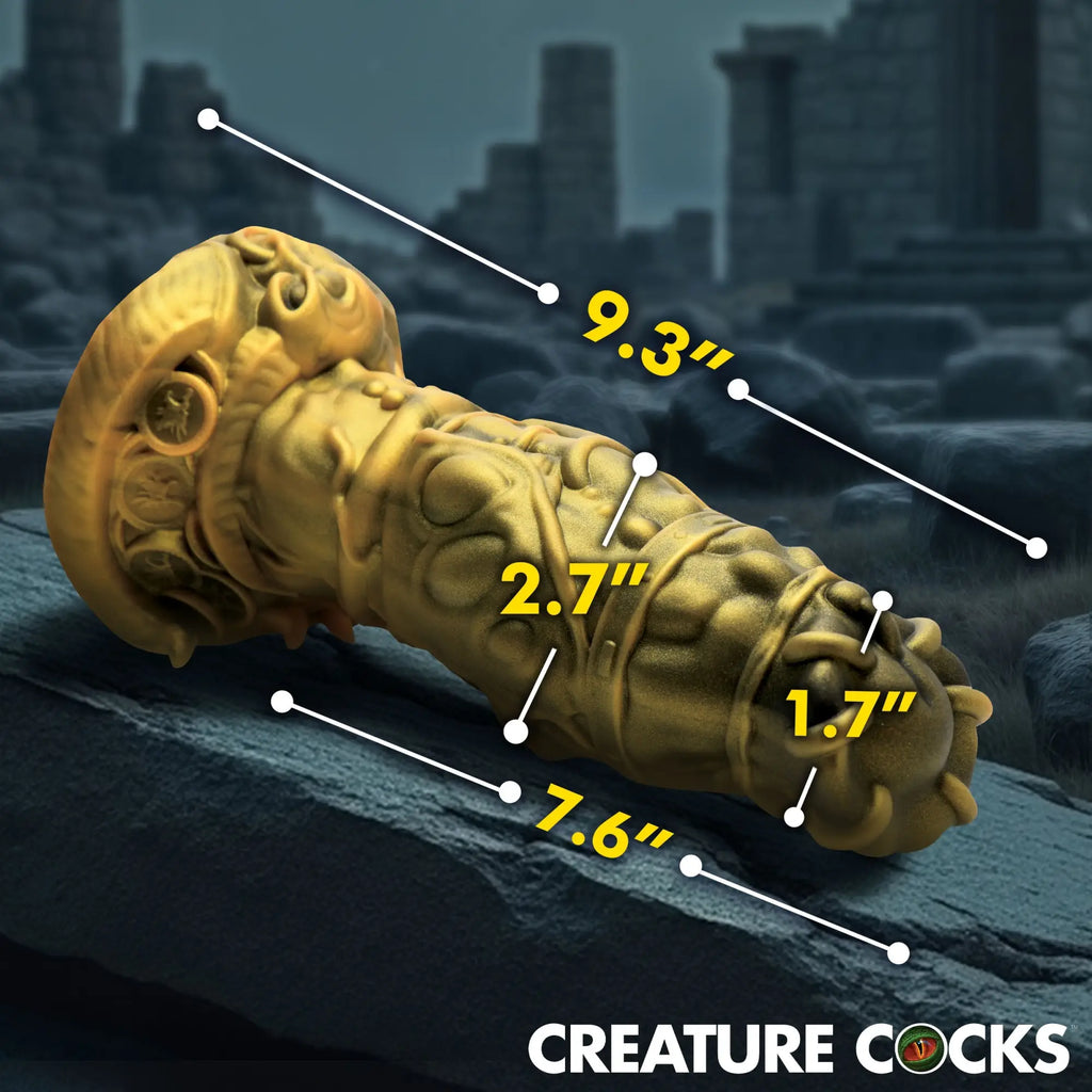 Creature Cocks King Minotaur gold silicone dildo with intricate textures and dimensions displayed on a stone background.