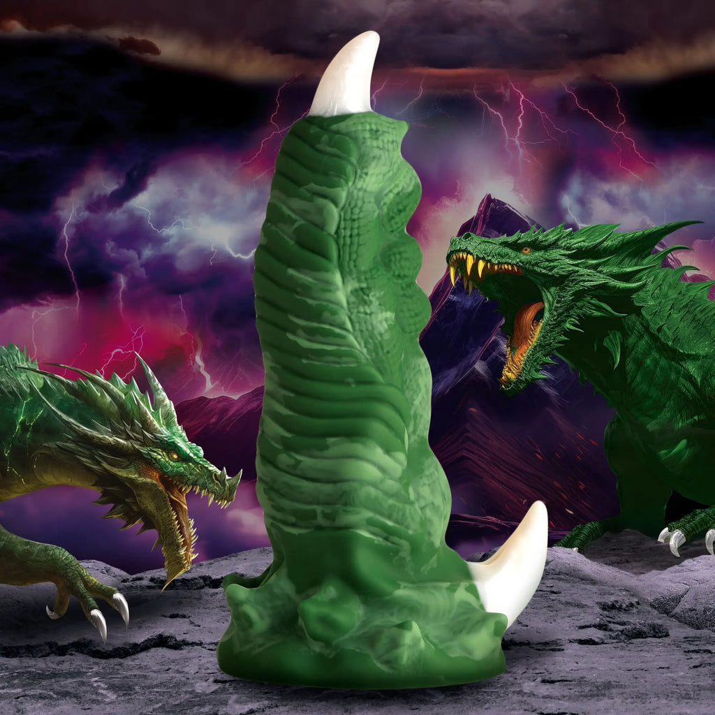 Creature Cocks Large Dragon Claw silicone dildo in green with textured scales and white claws against a stormy background.