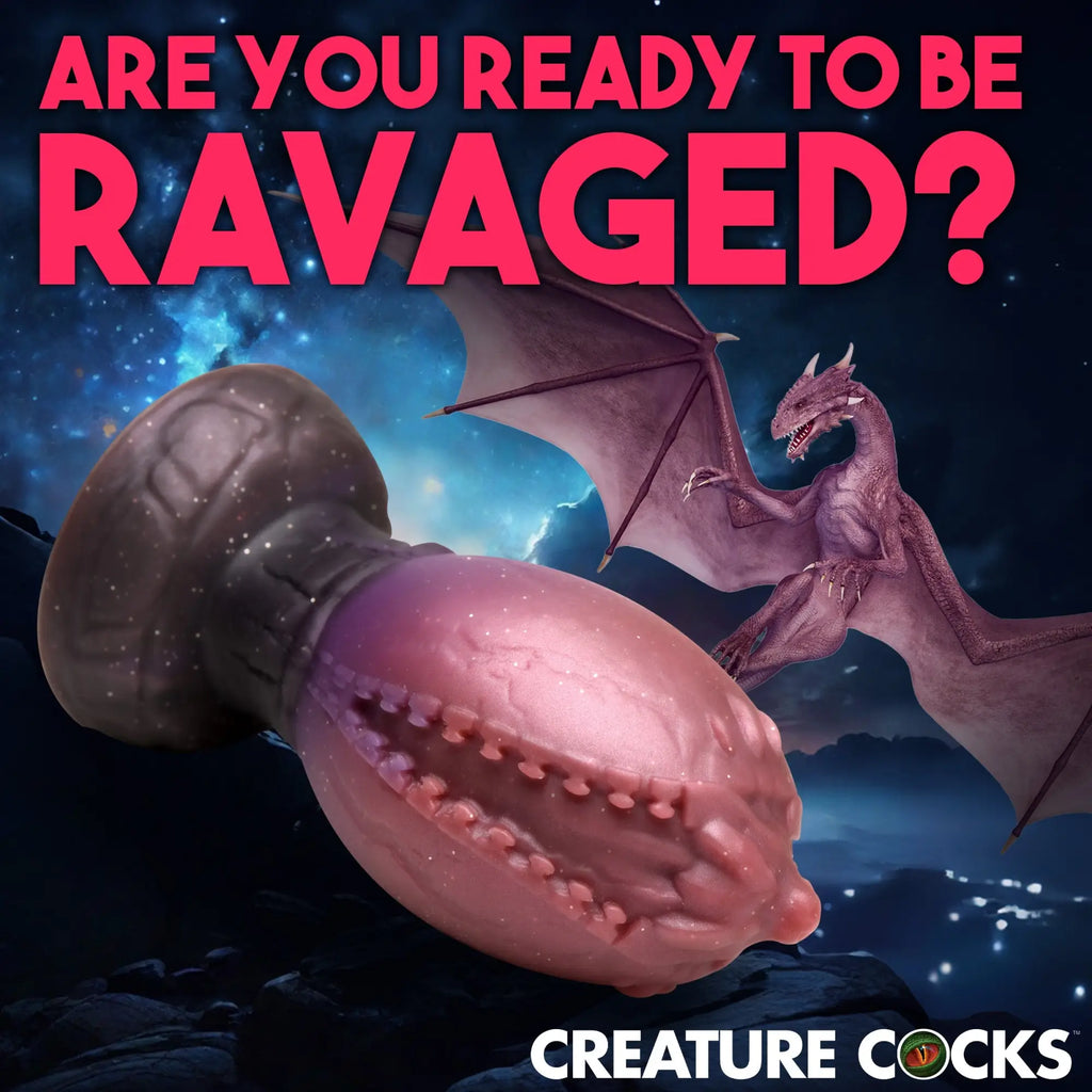 Creature Cocks Large Dragon Hatch silicone egg in pink and dark purple with a fantasy dragon graphic background.
