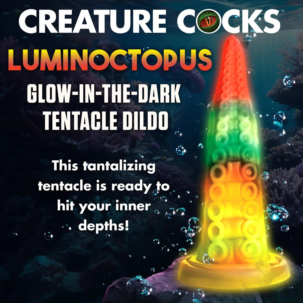 Creature Cocks Luminoctopus tentacle dildo in an underwater scene. The glowing silicone toy fades from red to yellow.