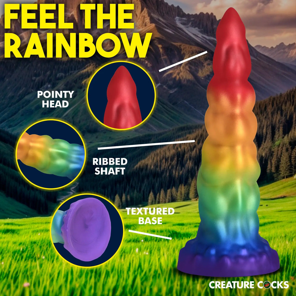 Creature Cocks Magic Rider unicorn dildo with a rainbow gradient, ribbed shaft, pointy tip, and textured base.
