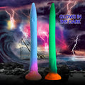 Two Creature Cocks Makara silicone snake dildos in blue and green, set against a stormy, lightning-filled seascape.