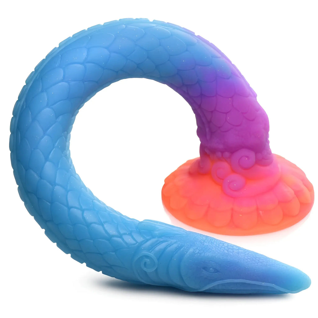 Creature Cocks Makara snake dildo in blue, purple, and orange ombre with detailed scale texture and a suction base.