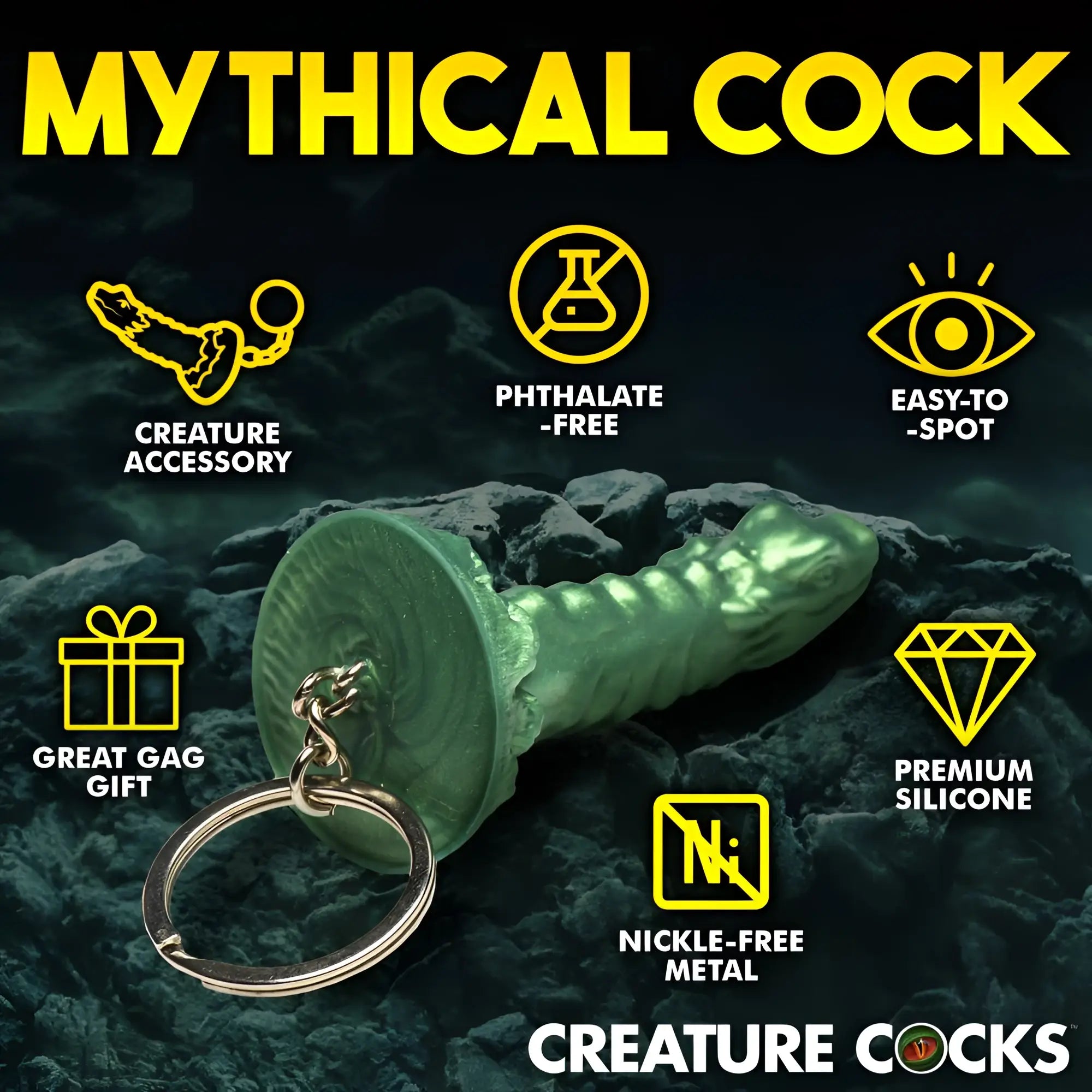 Creature Cocks mini dildo keychain in green, textured silicone with a metal keyring on a dark, rocky background.