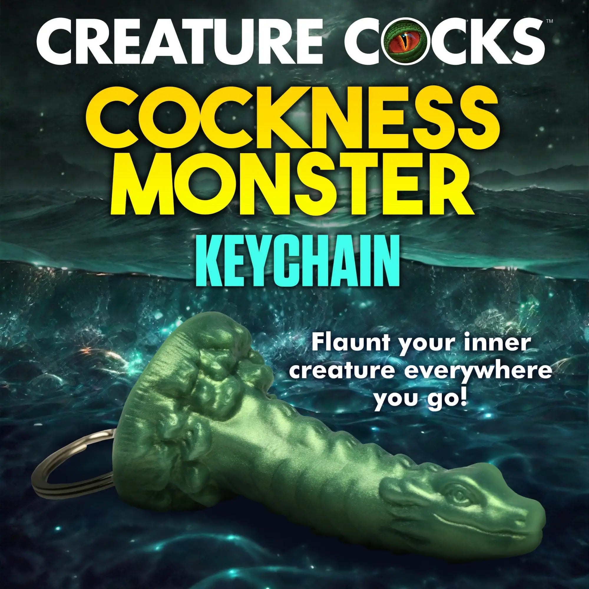 Creature Cocks mini dildo keychain in metallic green with a scaly, reptilian creature design, set against dark water.