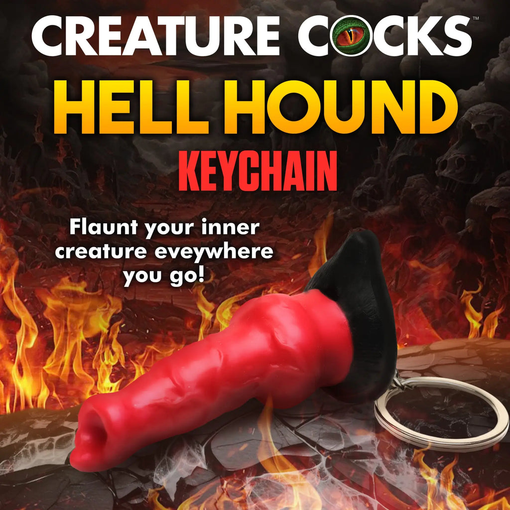 Creature Cocks Hell Hound mini dildo keychain with a red, textured shaft and black base on a fiery, dark background.