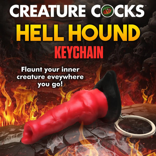 Creature Cocks Hell Hound mini dildo keychain with a red, textured shaft and black base on a fiery, dark background.