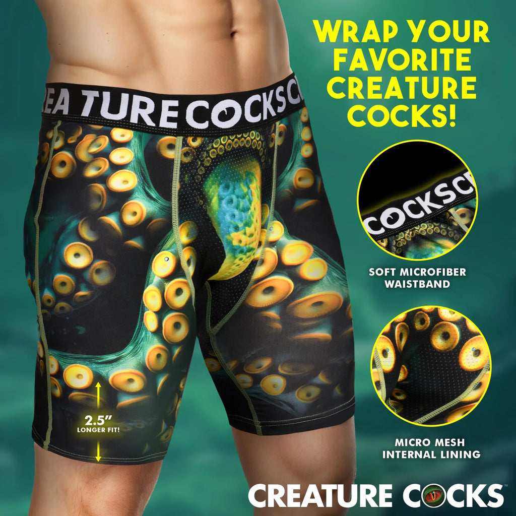 Creature Cocks Monstropus boxer shorts featuring a black and green tentacle print with bright yellow suction cups.