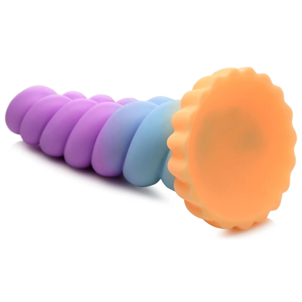 Creature Cocks Mystique silicone dildo: a spiral unicorn horn shape in pastel purple, blue, and an orange suction base.