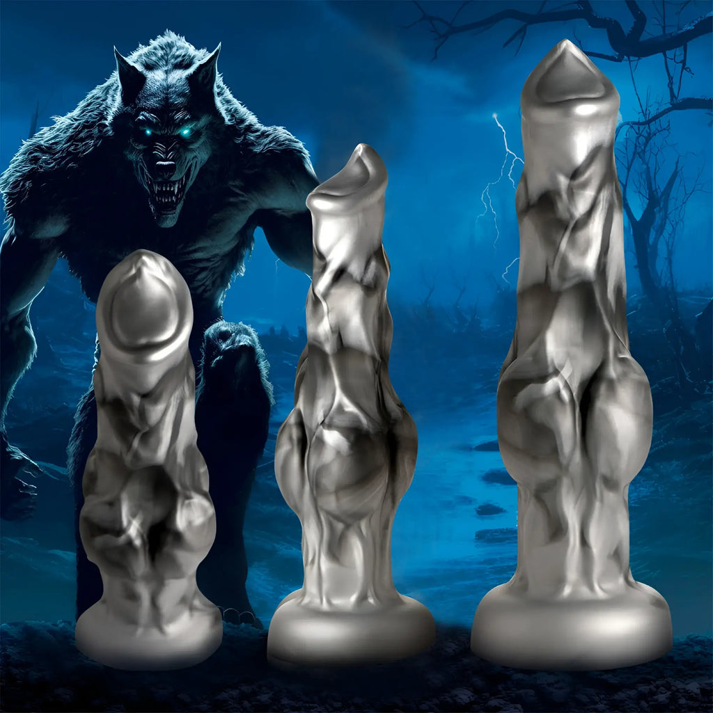 Three Creature Cocks Night Prowler silver-grey silicone dildos in varying sizes against a dark werewolf background.