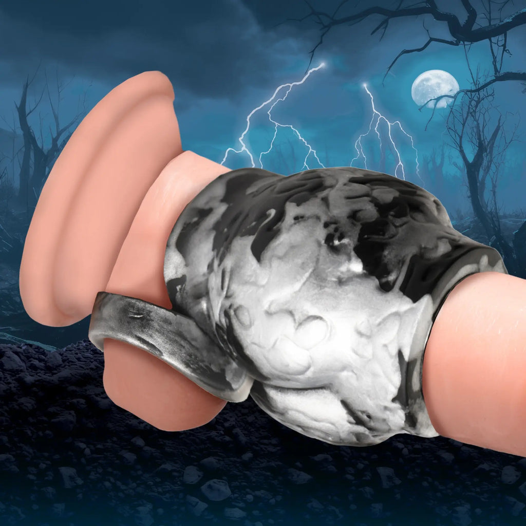 Creature Cocks Night Prowler: A black and white textured silicone girth enhancer with an attached ball strap.