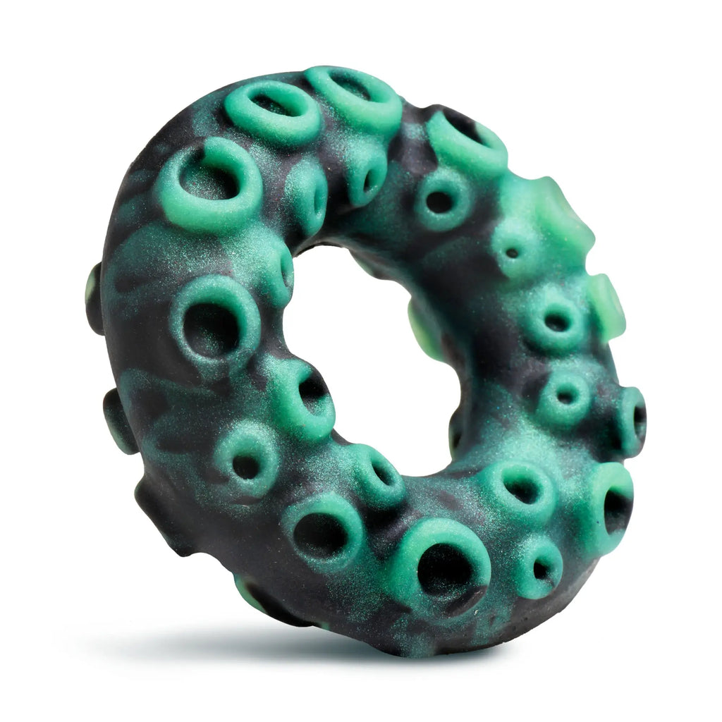 Creature Cocks Octo-Grip silicone cock ring in black and green with a textured octopus tentacle design and suction cups.